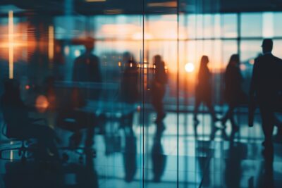 busy silhouettes in office building