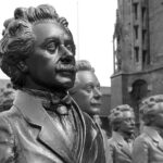 a row of statues depicting Albert Einstein
