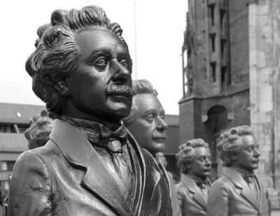 a row of statues depicting Albert Einstein